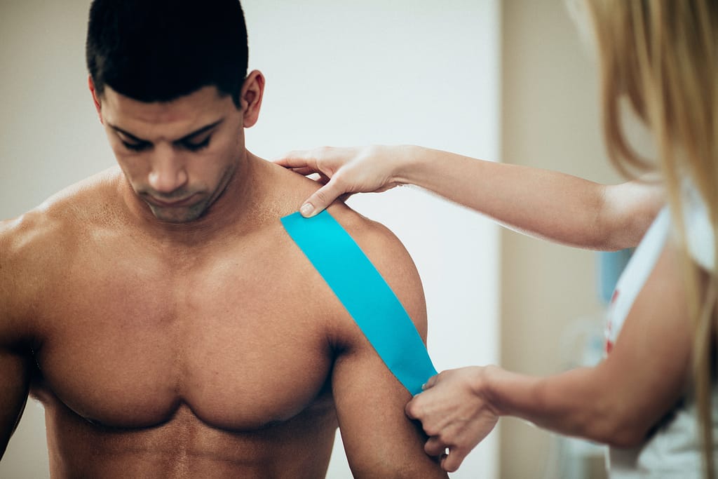 Physical therapist using kinesio tape